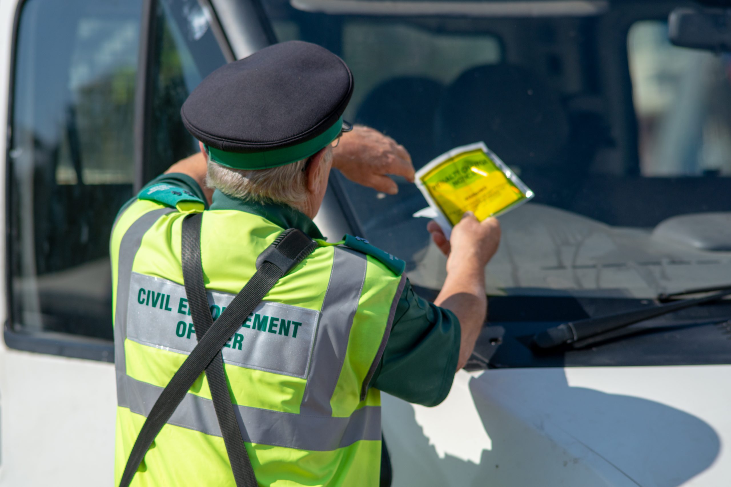 Warden gives parking fine to van