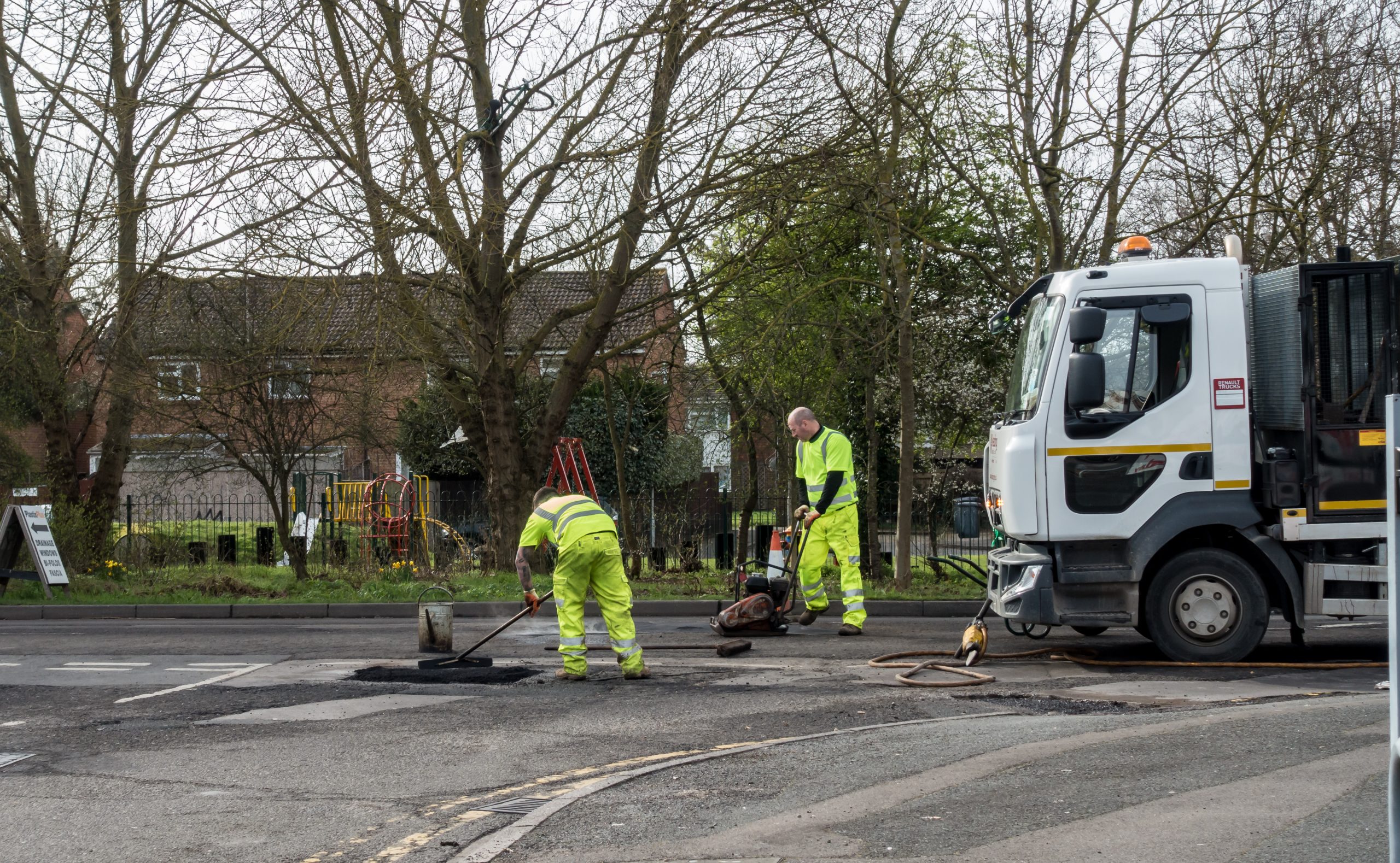 Workmen fixing potholes